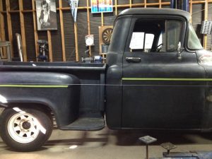 Using string and tape to line up the bed with the cab prior to mounting on the frame.