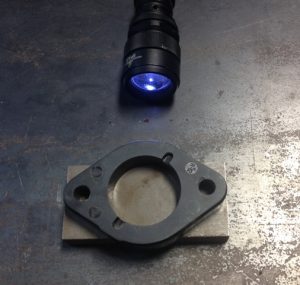 Diagnostic tools: a flashlight and a flat piece of metal.