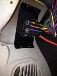 Fuse box above driver-side kick panel.