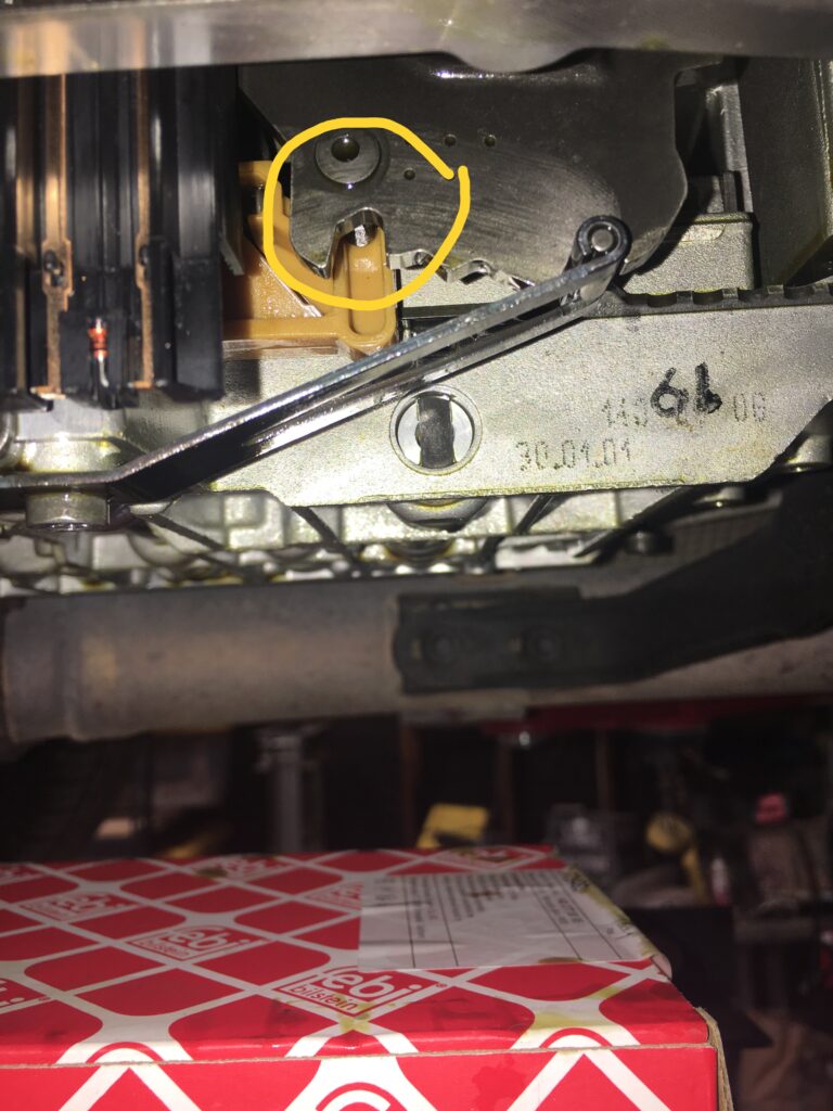 Close-up view of a Mercedes transmission showing the valve body and shift linkage, the conductor plate sits above the valve body.